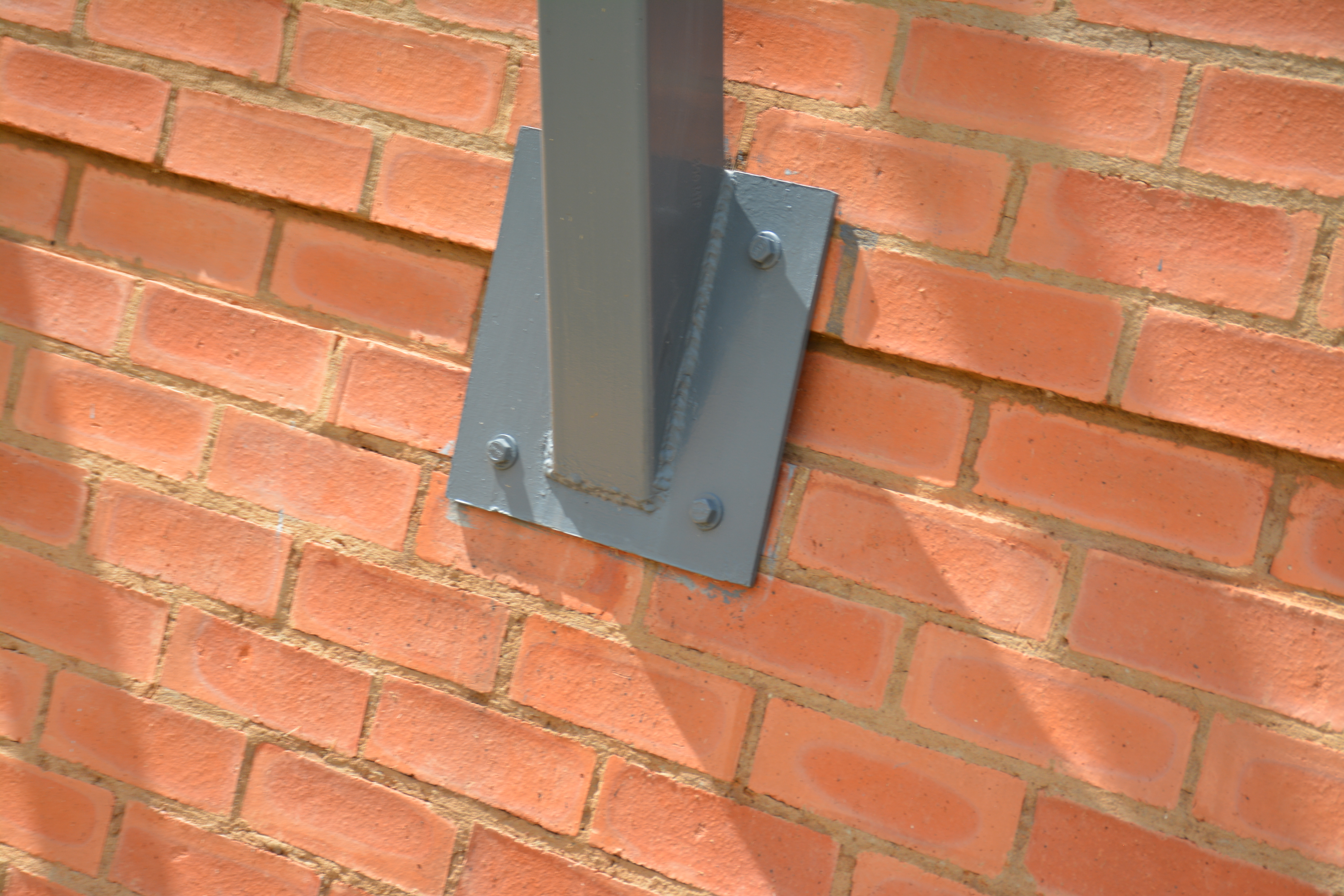 Brick wall detail with metal support and shadow